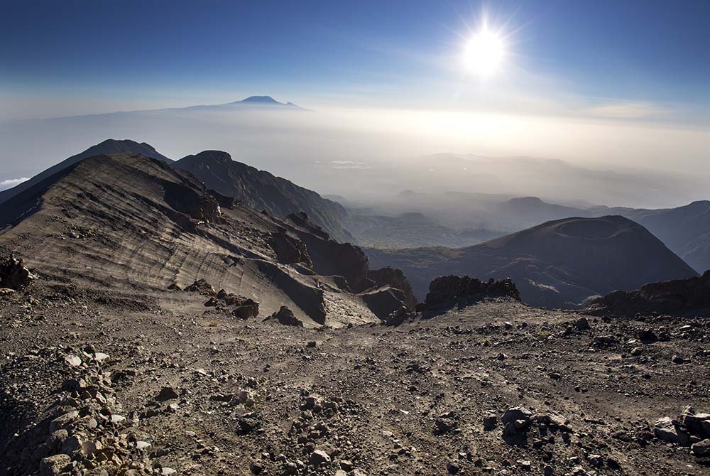 Mount Meru and Kilimanjaro in the distance
